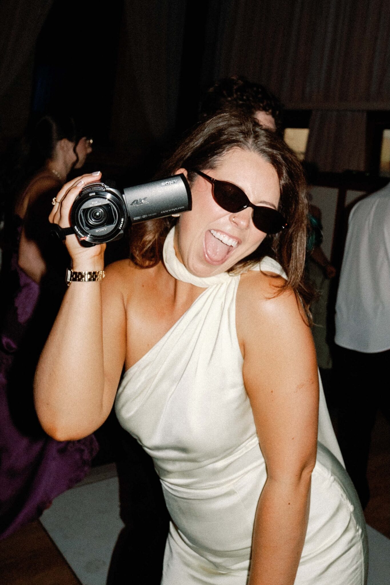 A guest filming the wedding with a camcorder